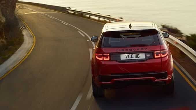 Range Rover Discovery (Red) driving on road