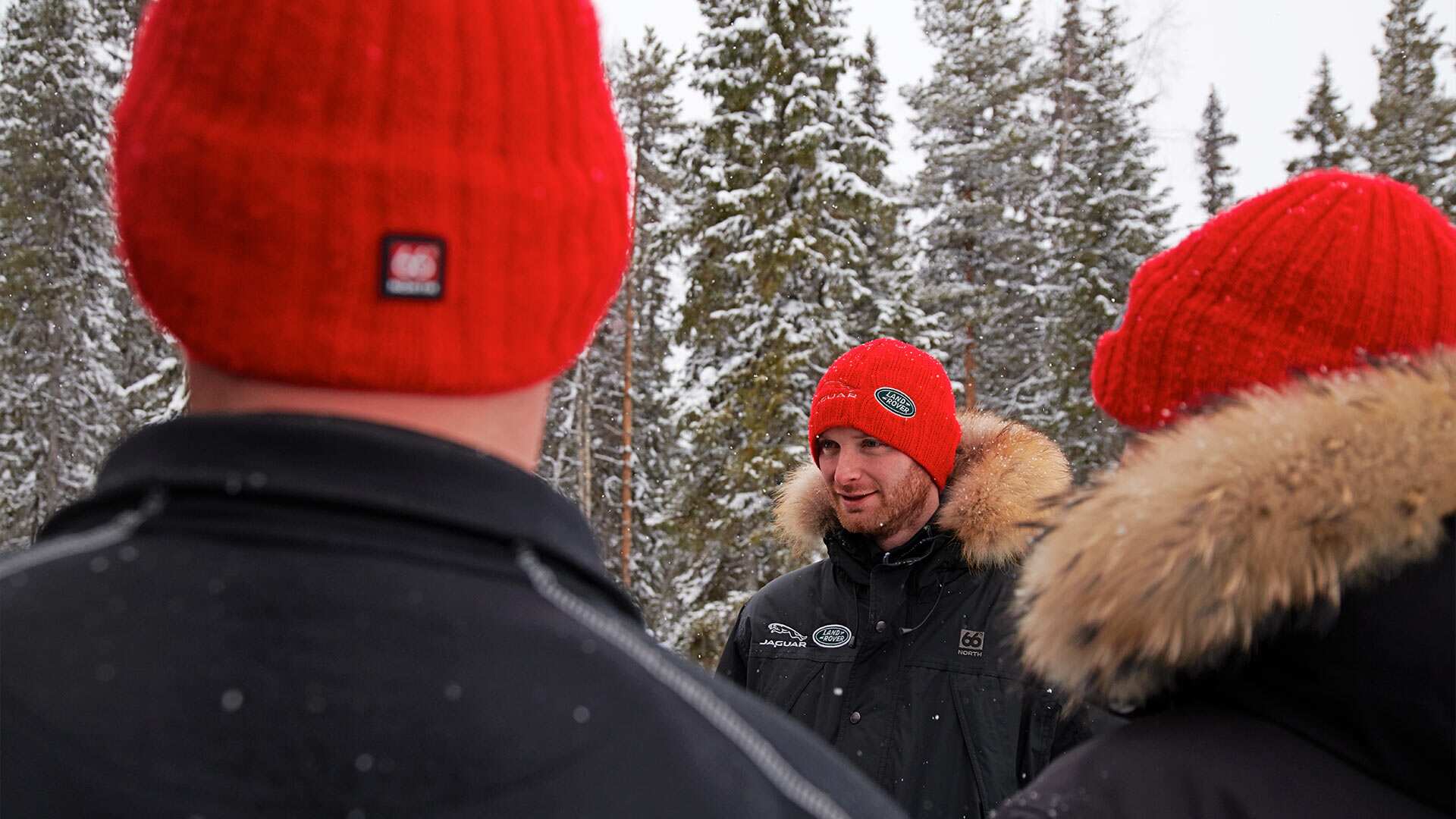 Three people in red beanies