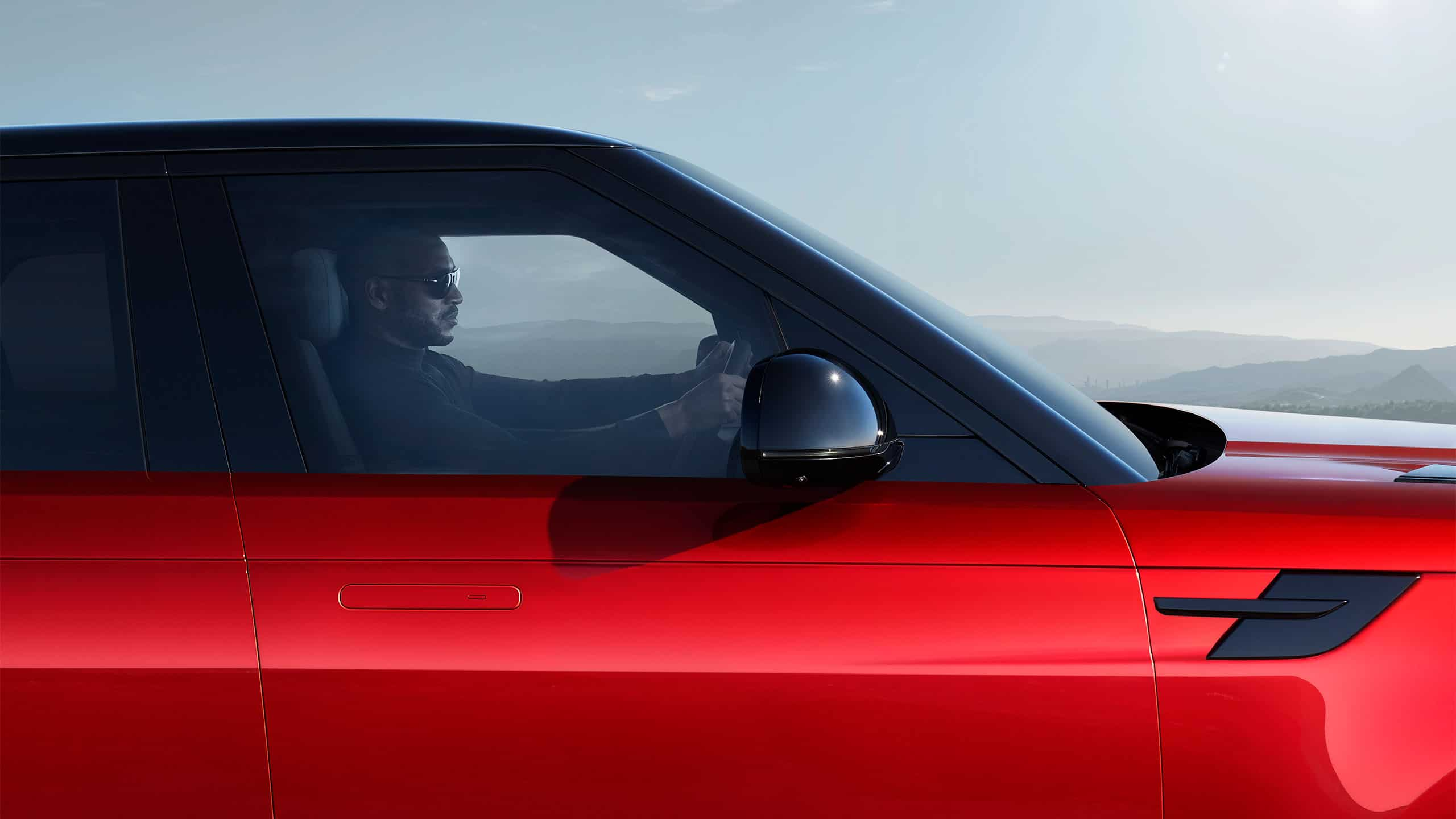 Man in Sunglasses, Driving a Range Rover Sport