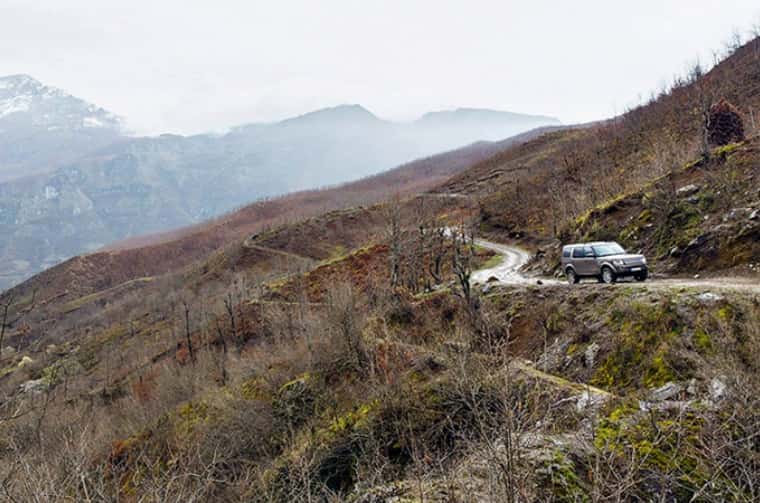 land rover discovery driving on mountain road 